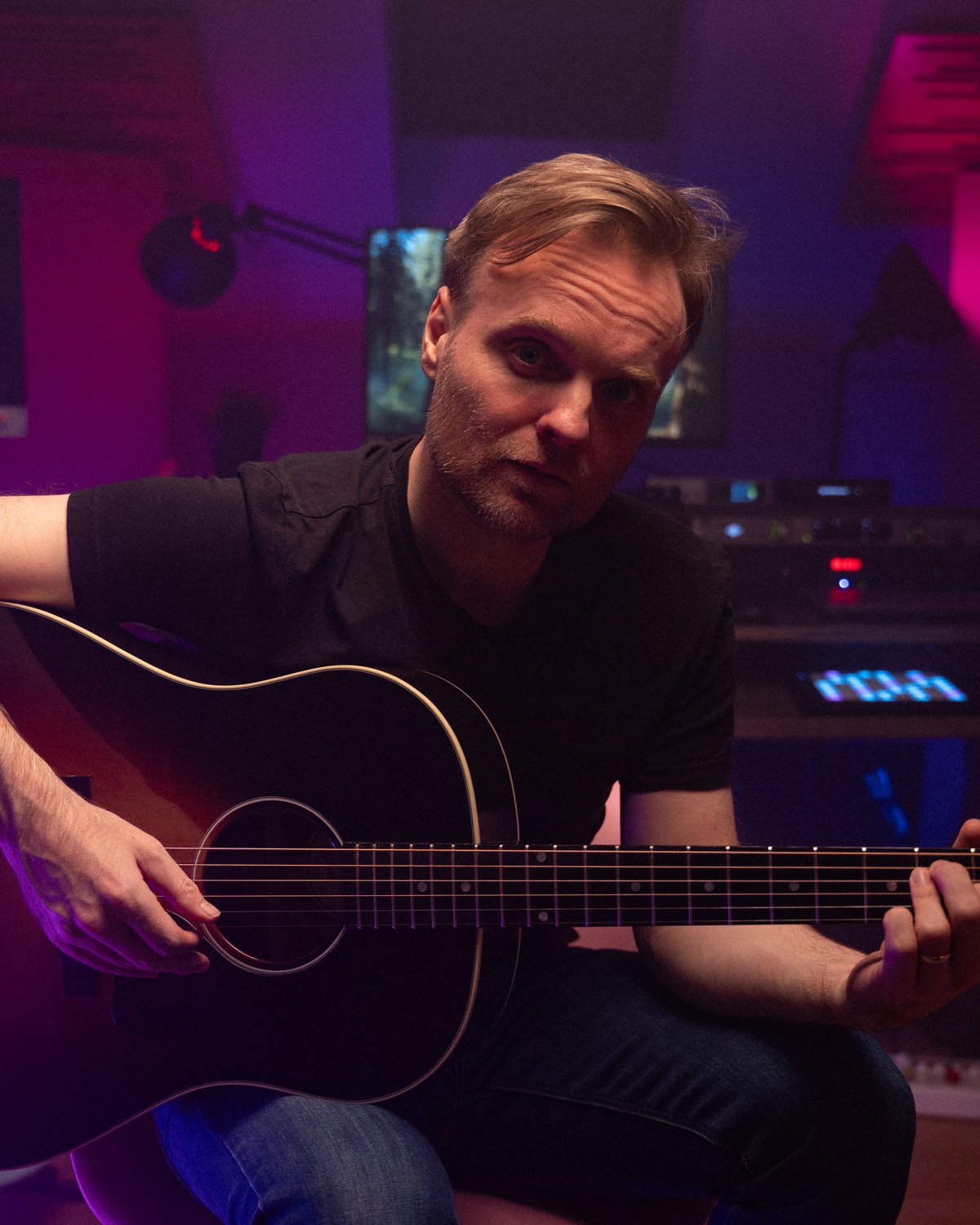 Daniel Joseph Healy in his studio with a Gibson acoustic guitar